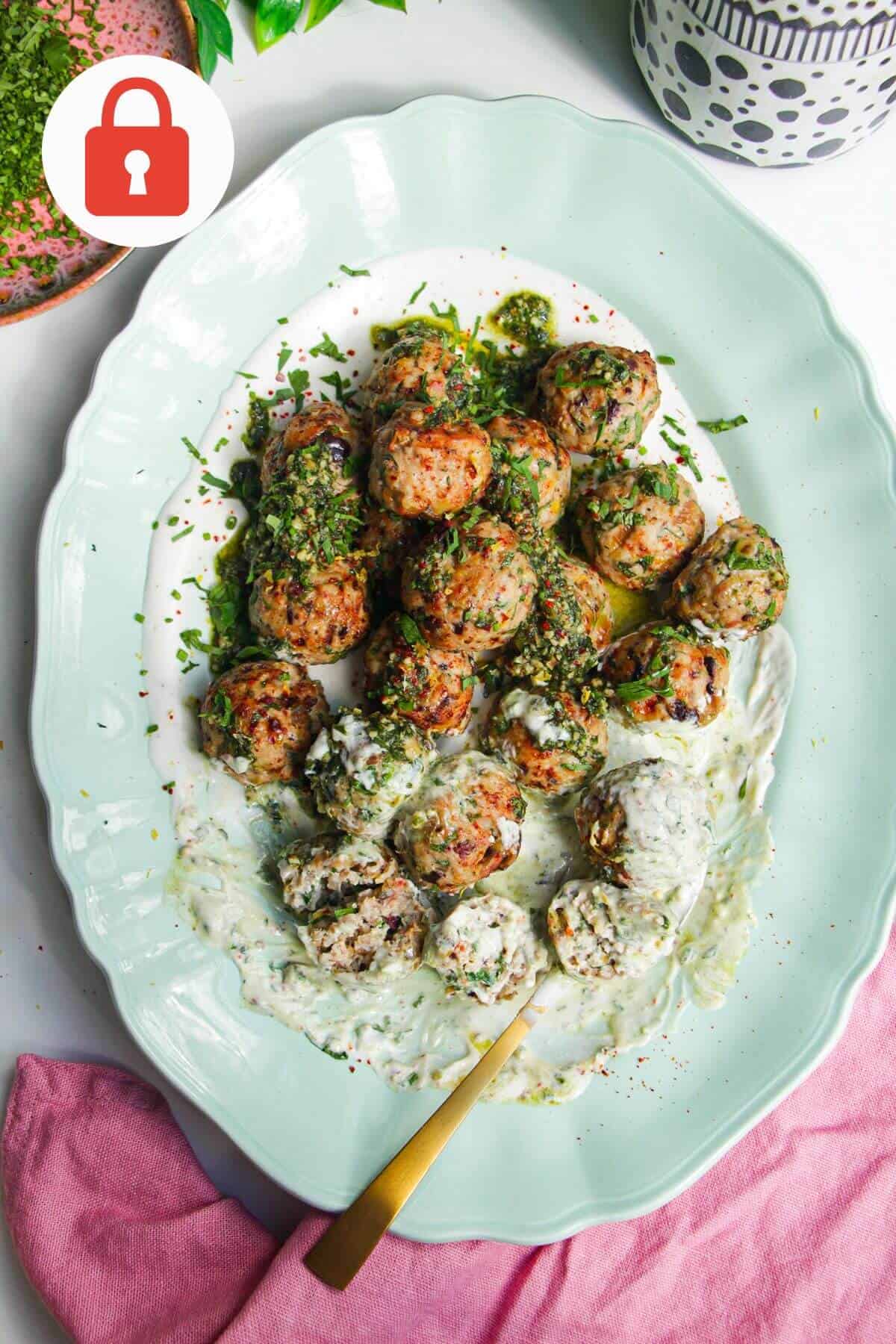 Lemon chicken meatballs on whipped feta with pesto.