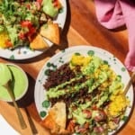 Two Mediterranean beef rice bowls, with green tahini sauce on the side.