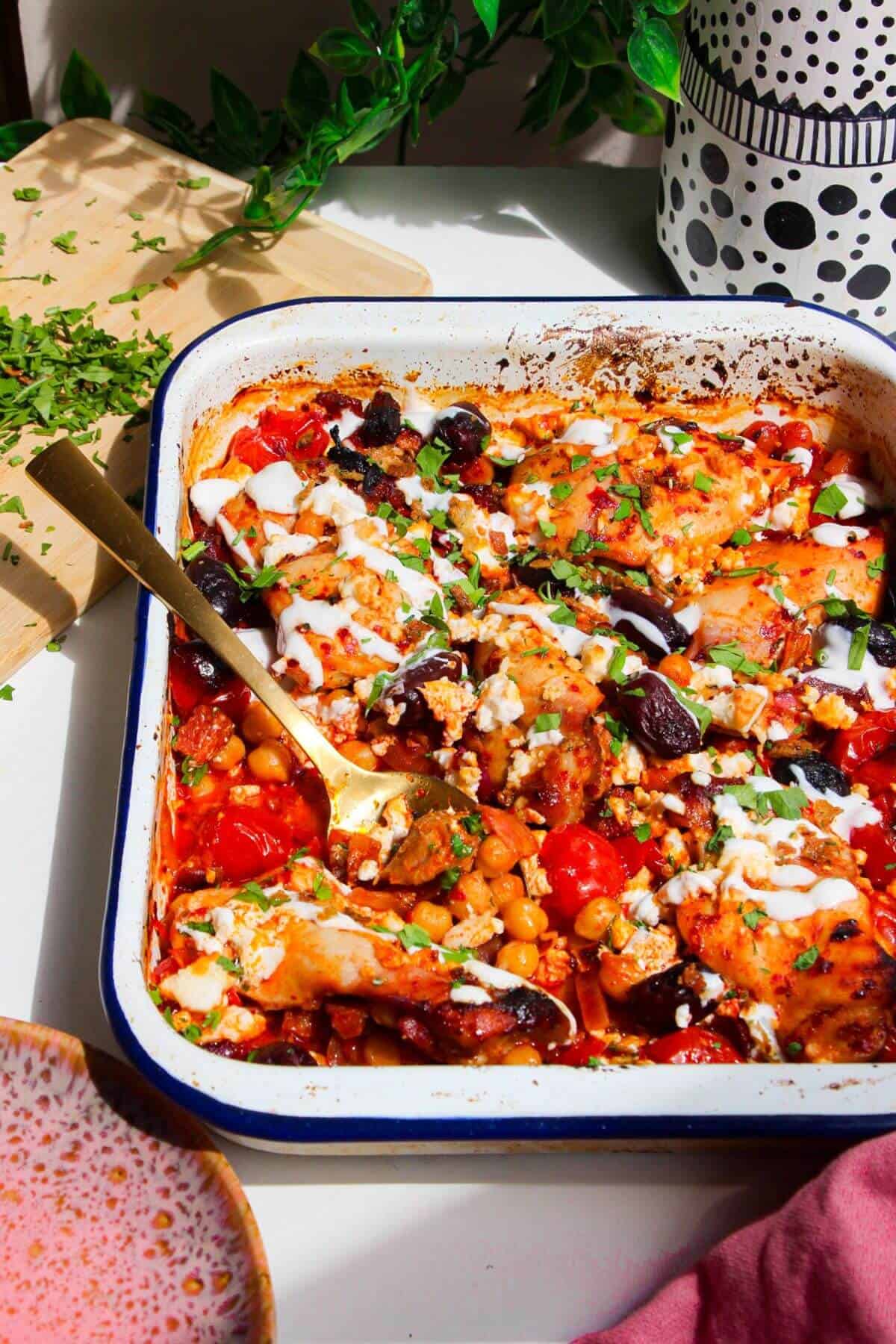 Harissa chicken baked with tomatoes, feta and chickpeas.