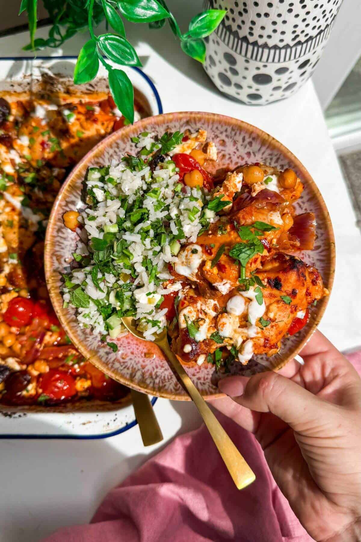 Harissa chicken baked with tomatoes, feta and chickpeas.