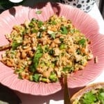 Satay chicken crunch salad in serving bowl with spoon.
