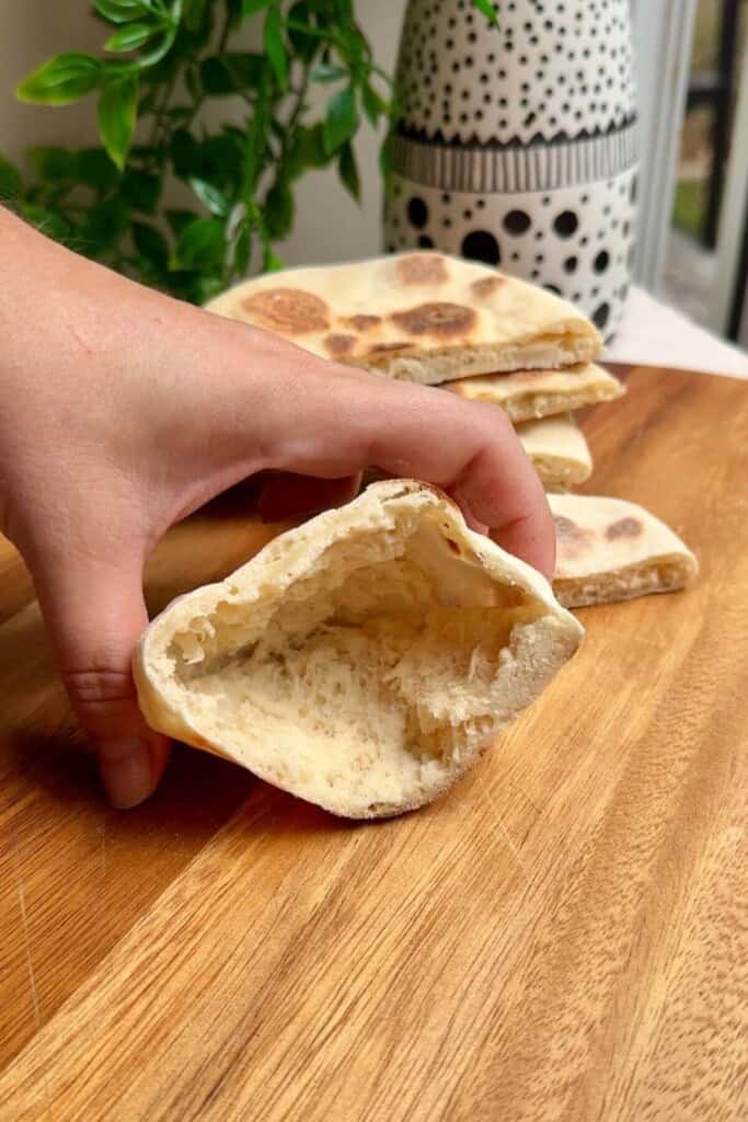 Hand holding flatbread open.