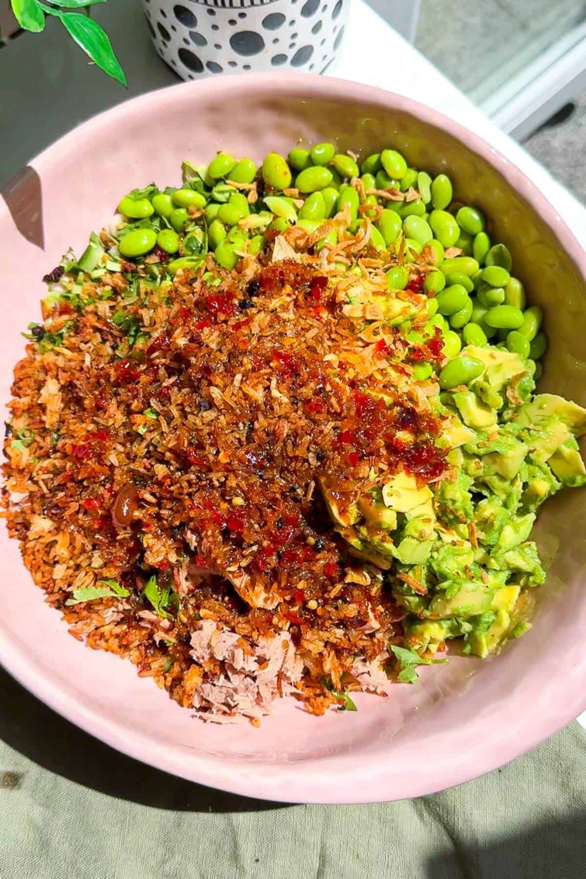 Ingredients for tuna crispy rice salad in a large bowl.