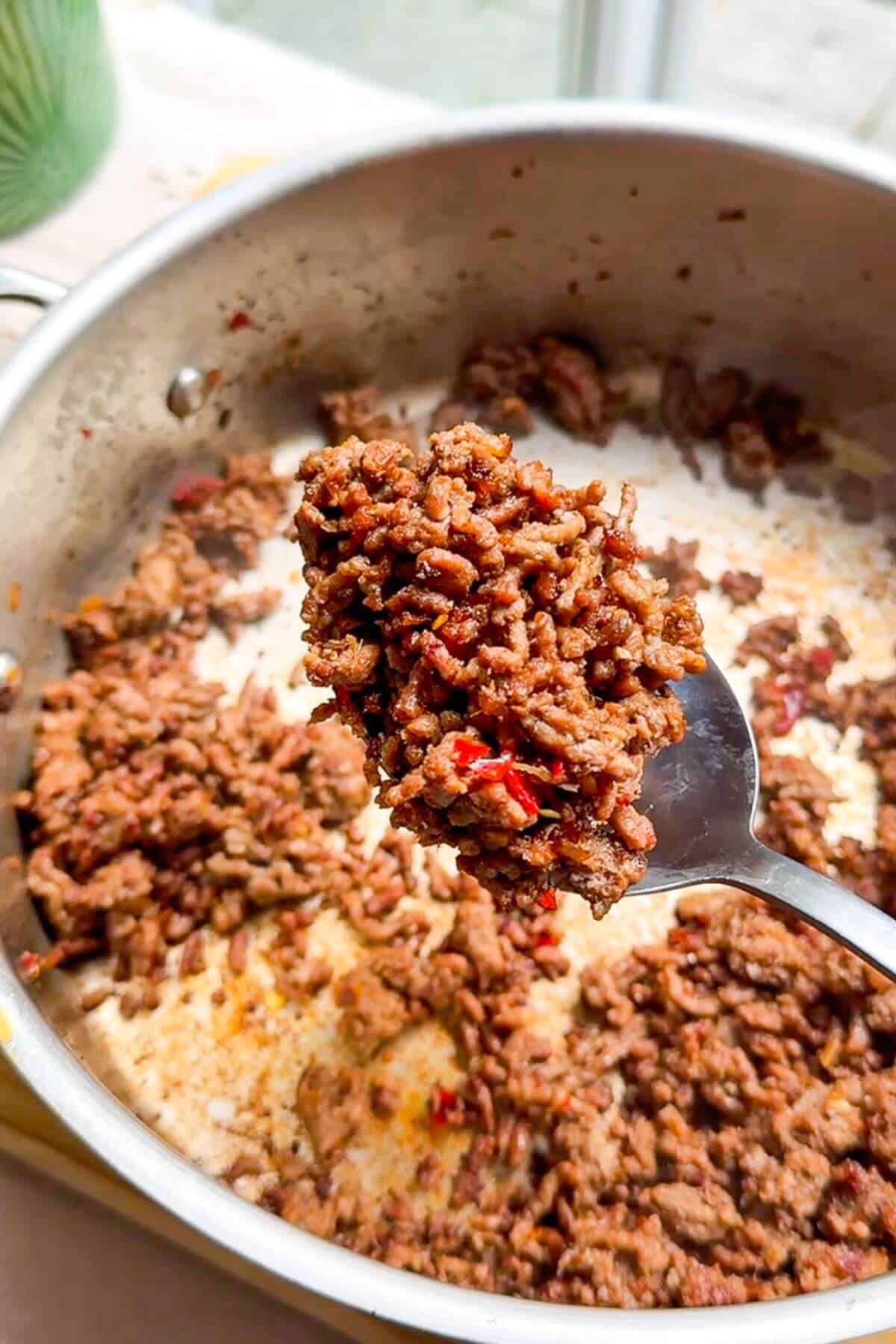 Sticky ground beef on large spoon.