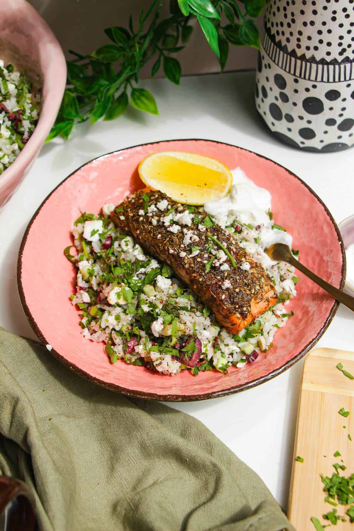 Za'atar crusted salmon, on herby rice salad in a bowl.