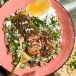 Za'atar crusted salmon, on herby rice salad in a bowl.