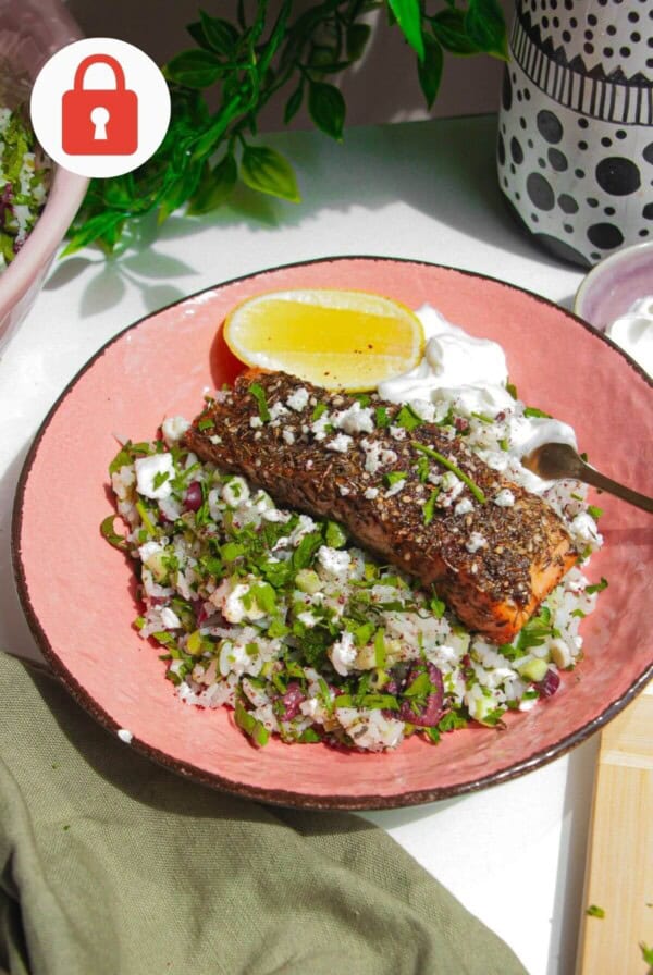 Za'atar crusted salmon served on warm herbed rice with lemon and greens.